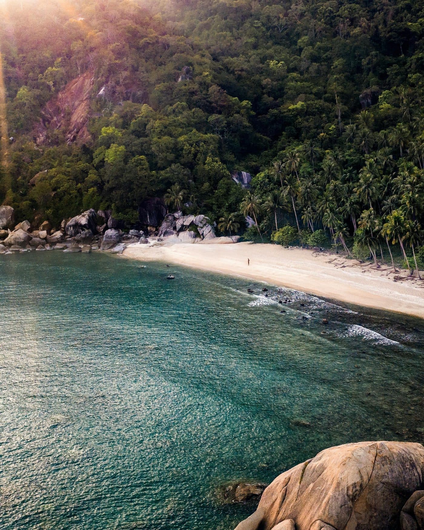 Diver descending in clear blue water during an open water course in Koh Tao