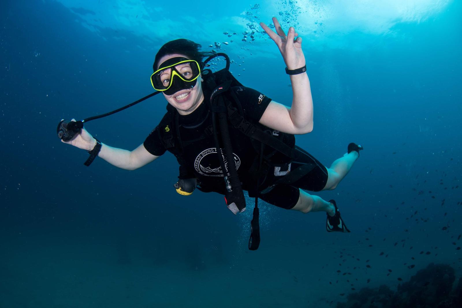 Divers signalling OK over Chumphon Pinnacle, Koh Tao